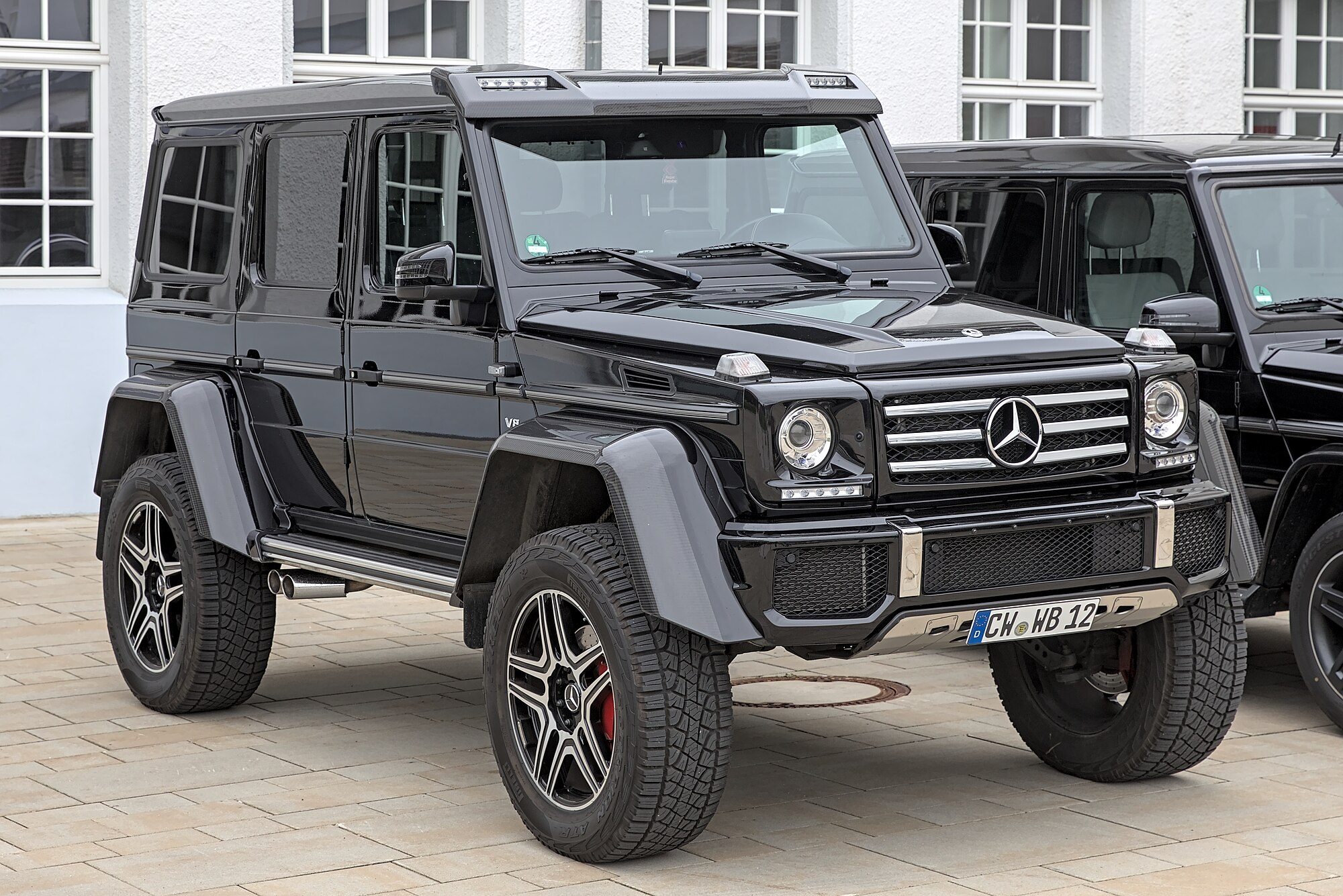 A black G 500 4×4² showing its wide fender flares and portal-axle ride height