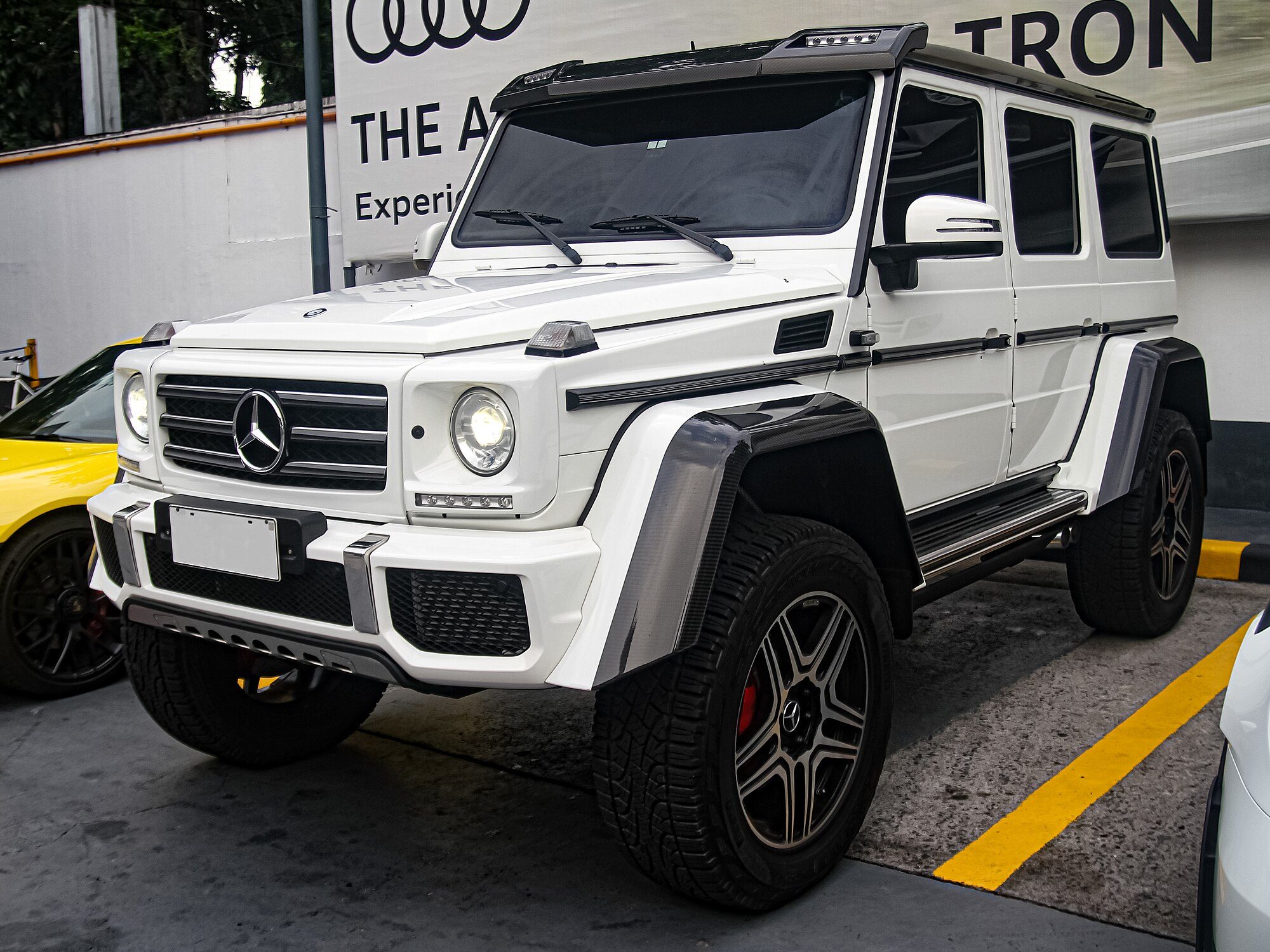 A polar white G 500 4×4² in a parking lot