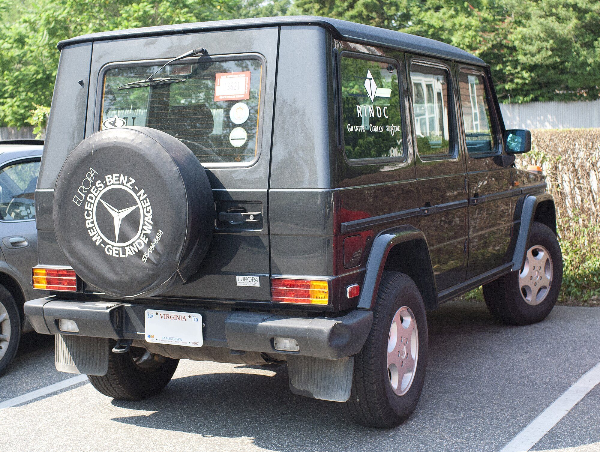 Rear of a dark 300 GE long-wheelbase W463 with an Europa International spare-wheel cover and badge
