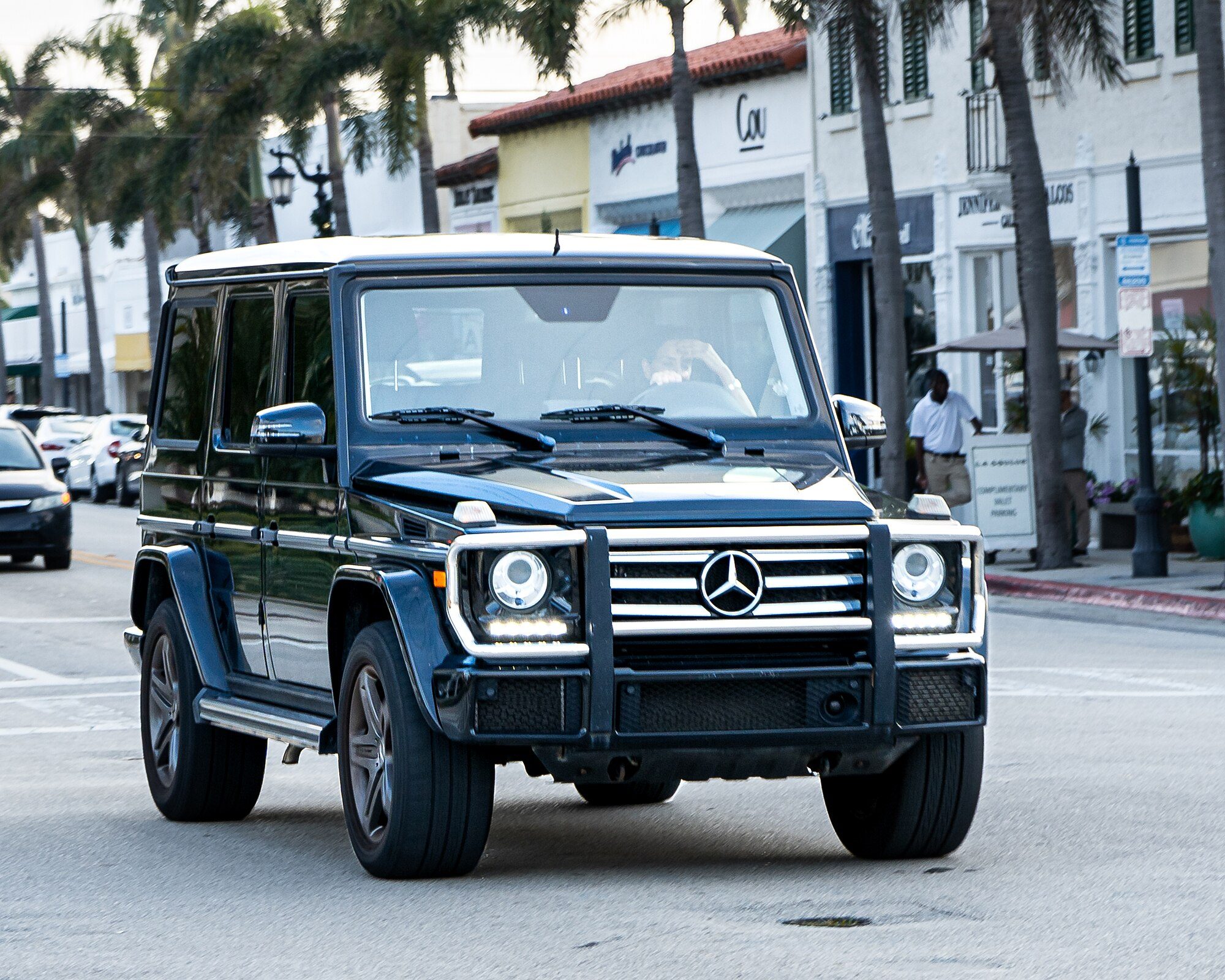 A black late W463 G 550 with LED running lights and a brush guard