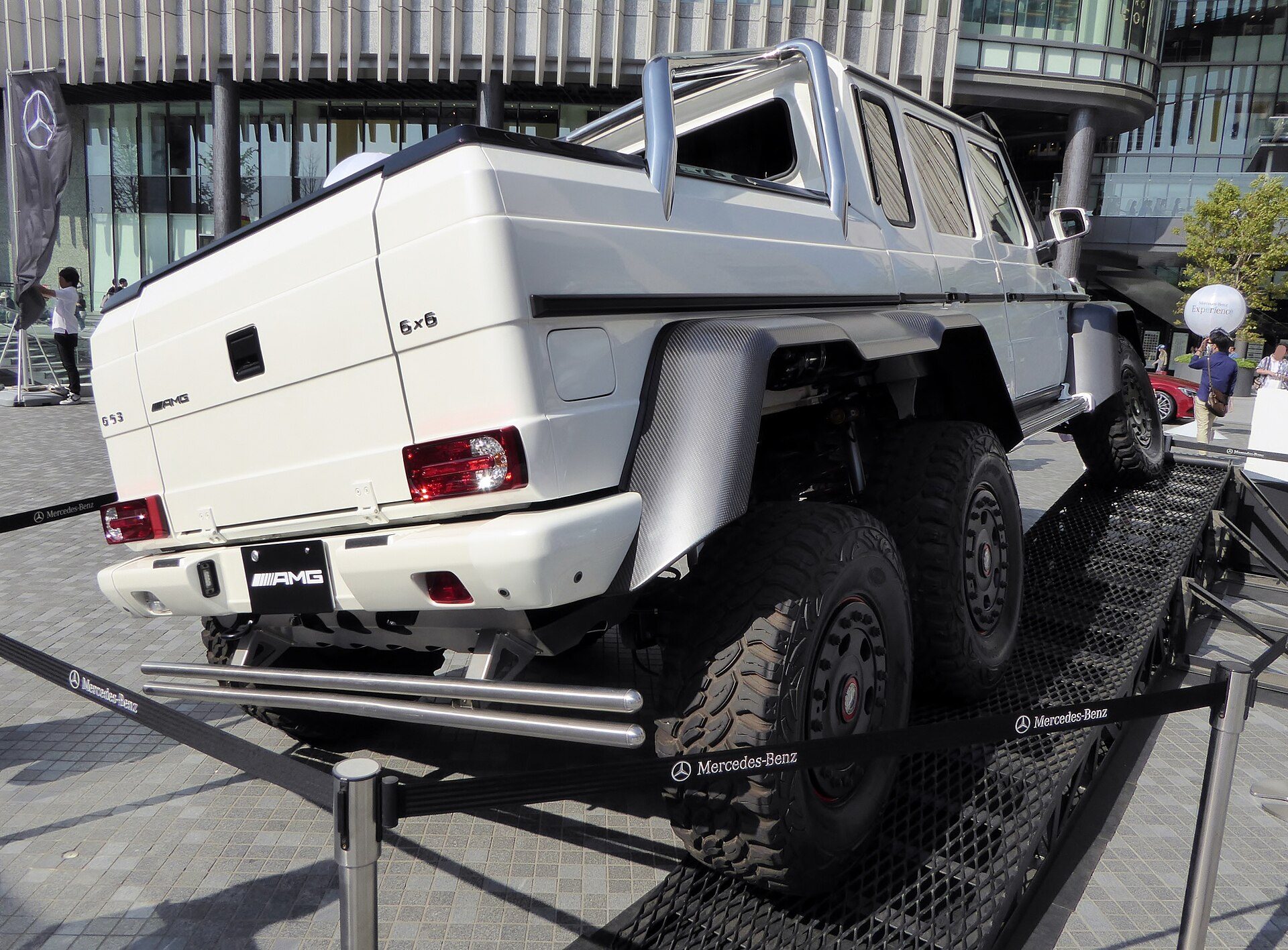 Rear view of a white G 63 AMG 6×6 on a display ramp showing its two rear portal axles