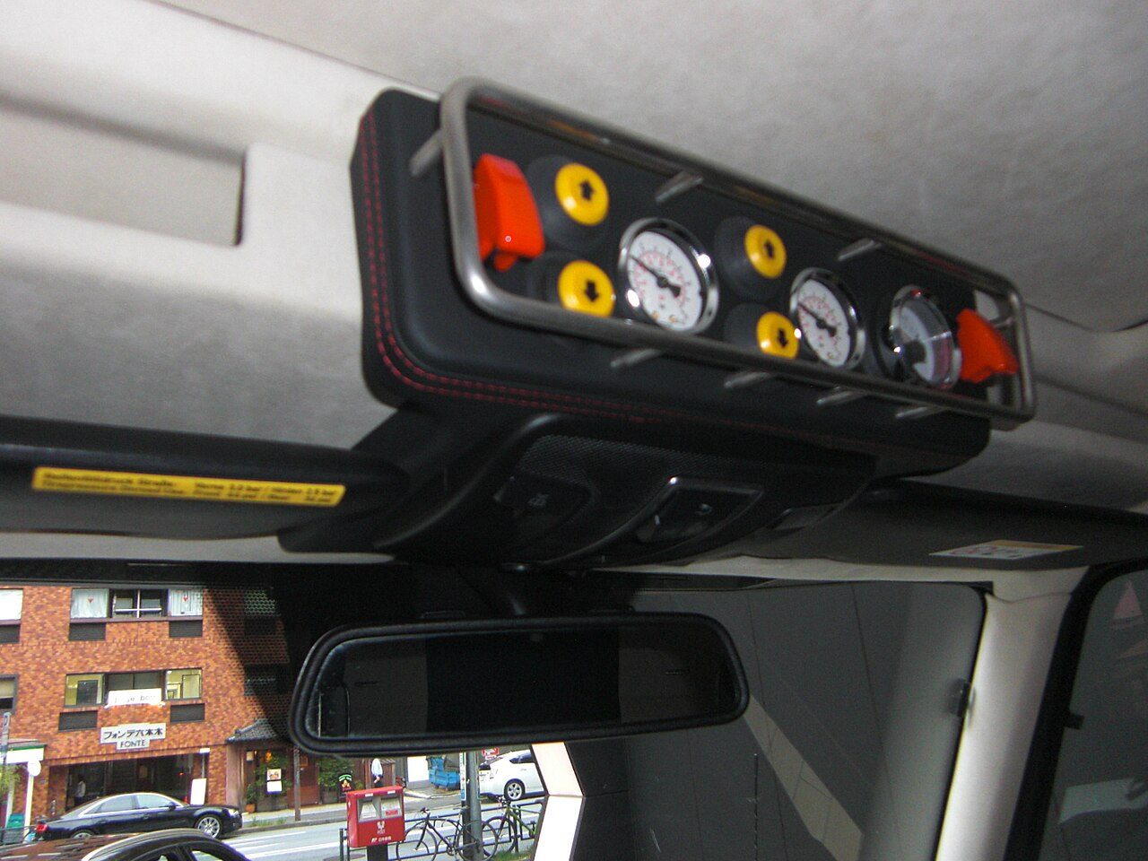 The overhead console of a G 63 AMG 6×6 with tyre-pressure switches and air gauges