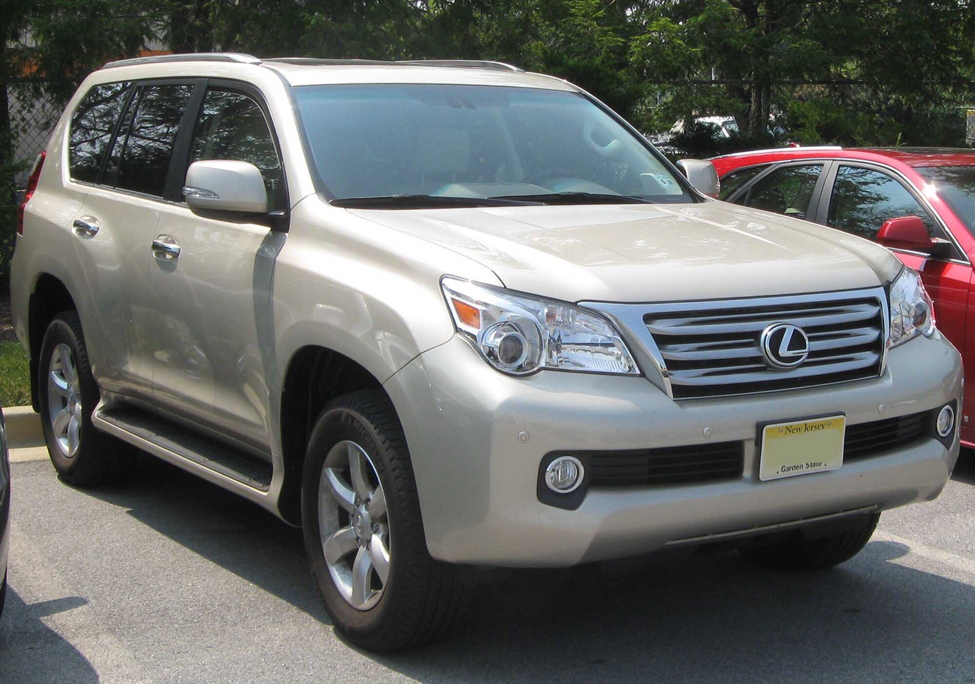 A champagne 2010 Lexus GX 460 with the original pre-2014 grille, parked on a street