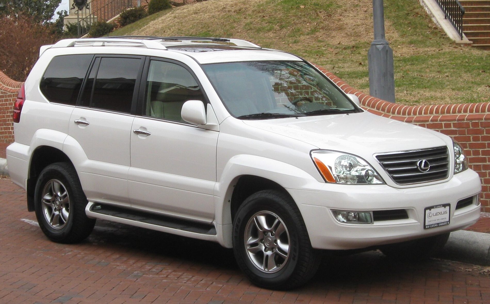 A white 2008–09 Lexus GX 470 in a car park in front of a grassy bank