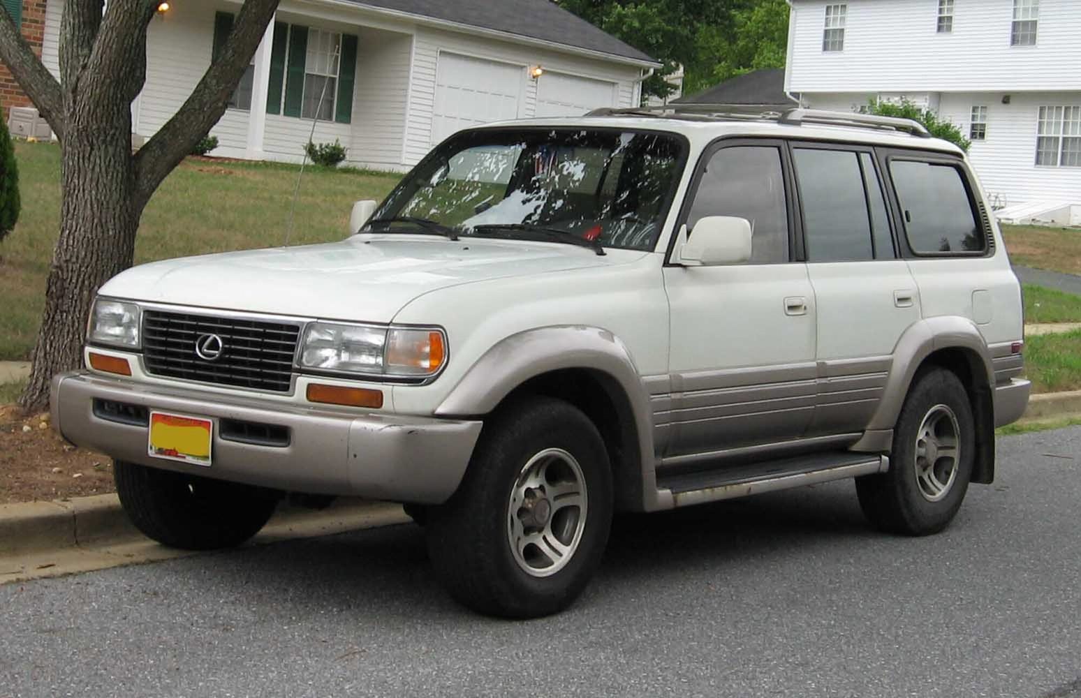 A white and silver two-tone Lexus LX 450 parked on a suburban street
