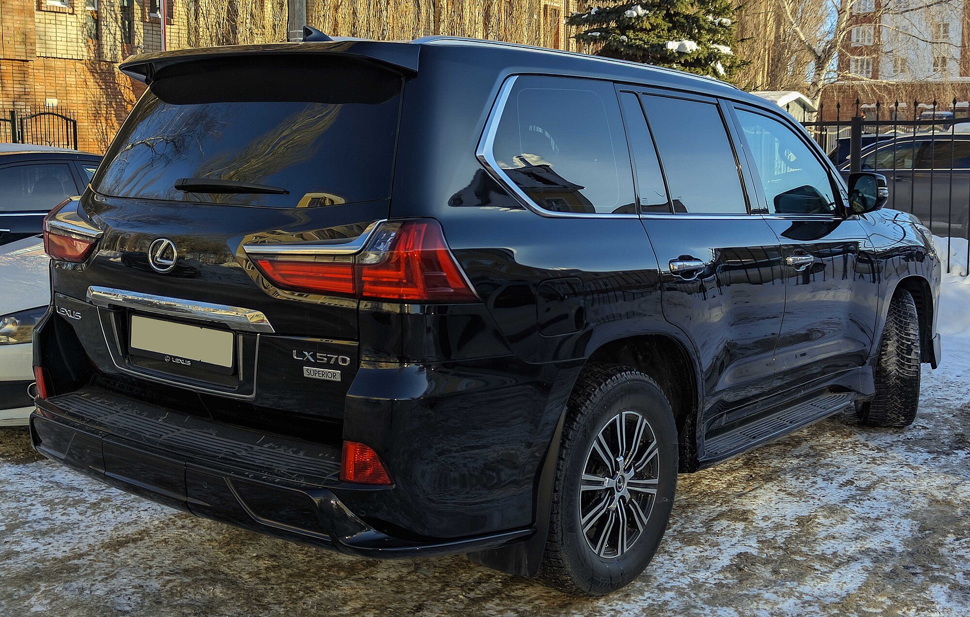 Rear view of a black 2018 Lexus LX 570 on packed snow